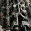 Diesel engine with the cam cover removed, showing both camshafts and the injector pipes