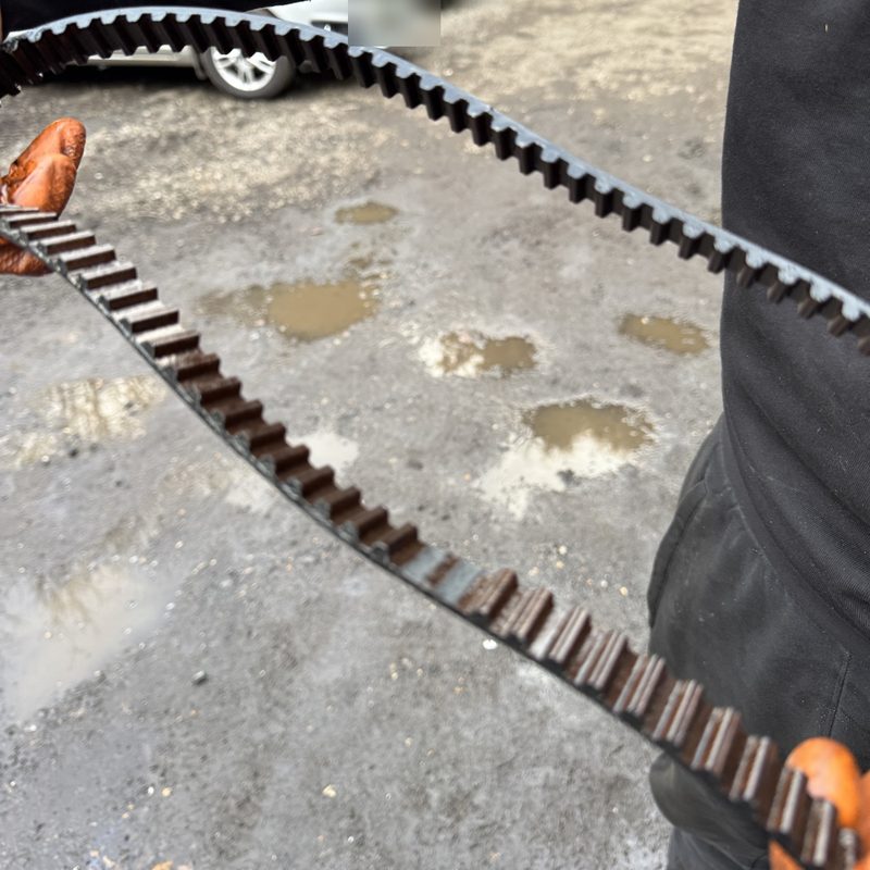 Old timing belt held up after removal from an engine