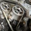 Timing belt fitted over twin camshaft sprockets with the engine front cover removed